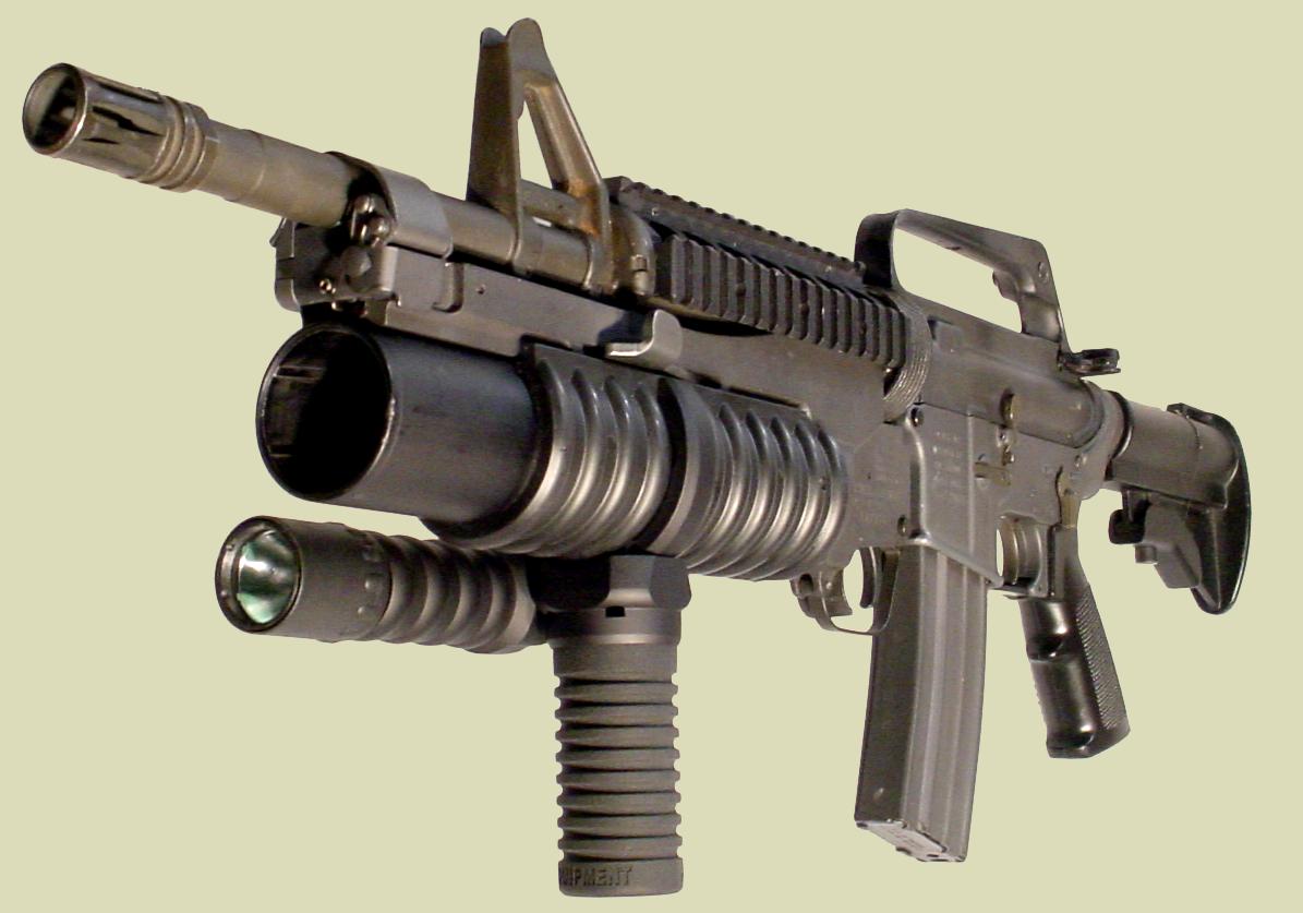 Photo: M4 rifle with the M203 grenade launcher. The M203grip with the Tactical Light is mounted on to the M203 handguard.